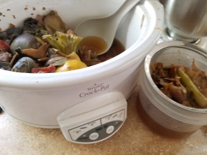 Separating cooked scraps from the broth.
